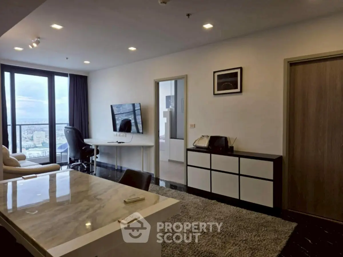 Modern living room with city view, sleek furniture, and open layout in high-rise apartment.