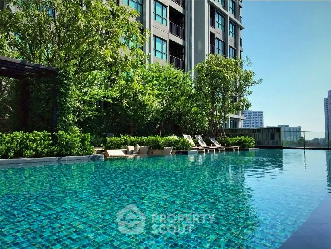 Luxurious high-rise apartment with stunning pool and lush greenery, perfect for urban living.