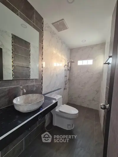 Modern bathroom with marble tiles and sleek fixtures
