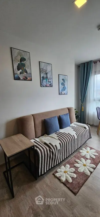 Charming living room with cozy sofa, stylish decor, and natural light for a welcoming ambiance.