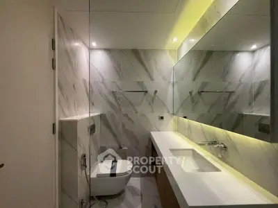 Luxurious modern bathroom with marble walls and sleek fixtures