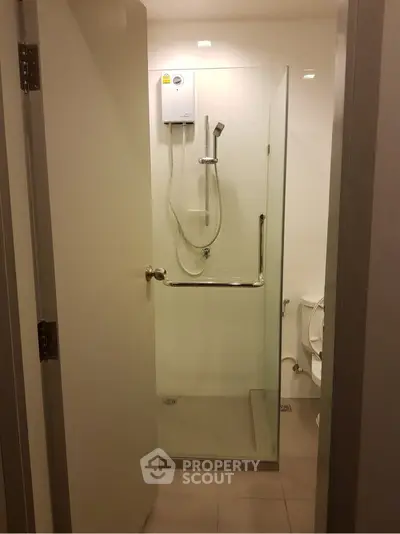 Modern bathroom with glass shower enclosure and water heater