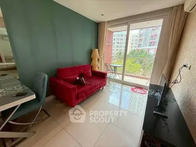 Chic living room with red sofa and balcony view in modern apartment.