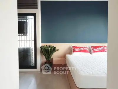 Modern bedroom with stylish decor and large window for natural light.