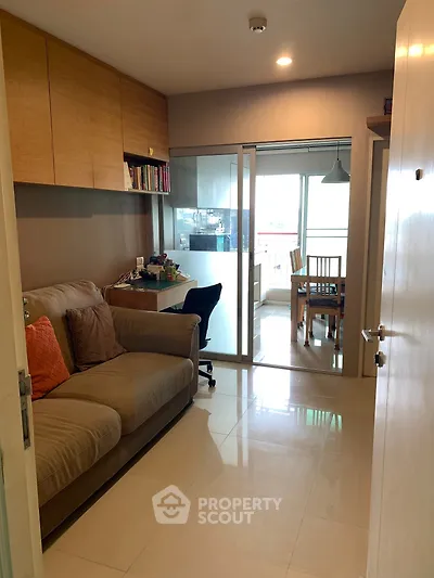 Cozy living room with sliding glass doors leading to dining area and balcony view.