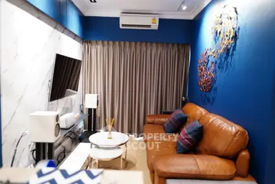 Stylish living room with leather sofa, modern decor, and wall-mounted TV in a cozy apartment.