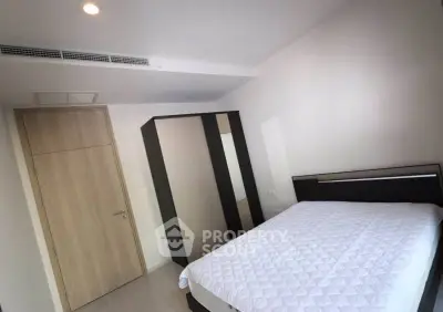 Modern bedroom with sleek wardrobe and cozy bed in minimalist design.