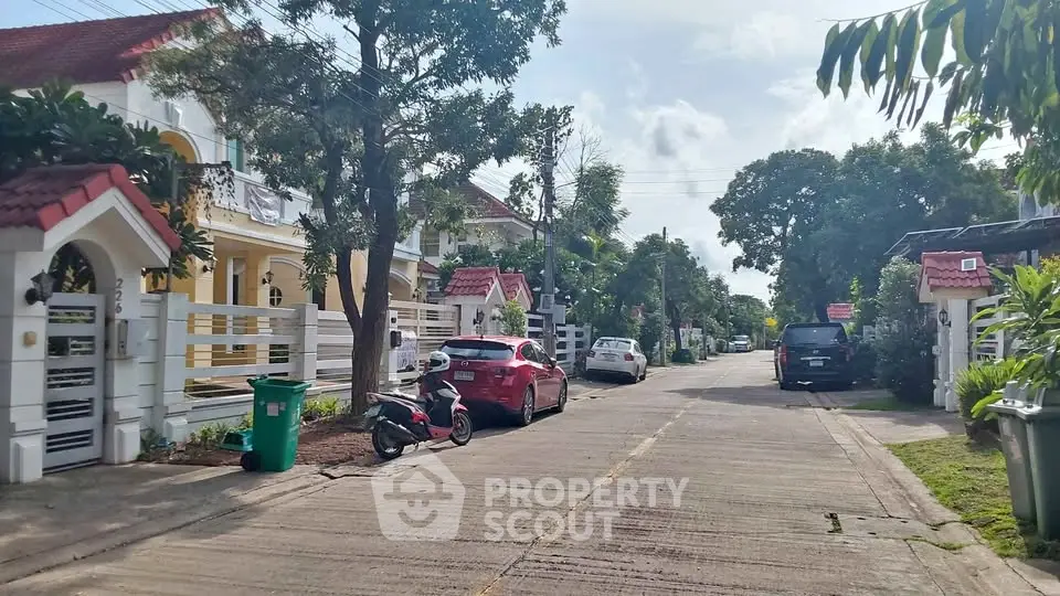 Charming suburban street with modern houses and lush greenery, perfect for family living.