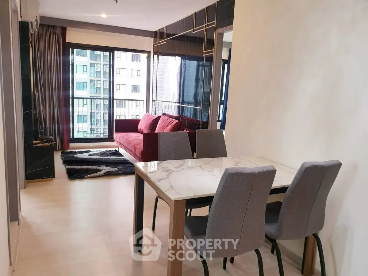 Modern living room with stylish decor and large windows offering city views