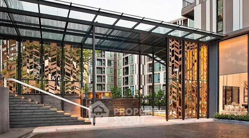 Modern apartment building entrance with stylish glass and metal design