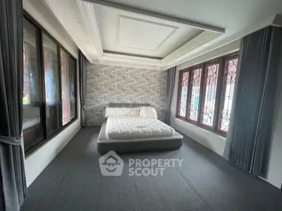 Spacious bedroom with modern design and large windows for natural light