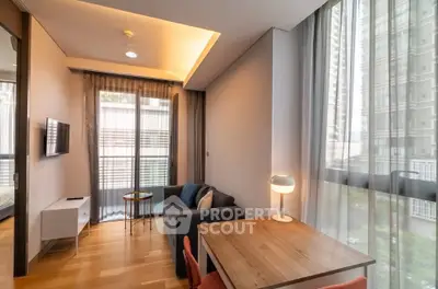 Modern living room with large windows and stylish furniture in a high-rise apartment.