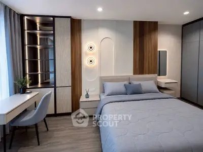 Modern bedroom with stylish decor, featuring a cozy bed, elegant lighting, and a sleek workspace.