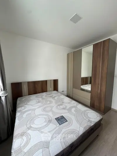 Modern bedroom with stylish wardrobe and comfortable bed in a well-lit space.