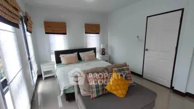 Cozy bedroom with stylish decor and ample natural light