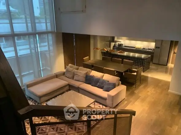 Luxurious open-plan living room with modern kitchen and stylish decor, perfect for entertaining.