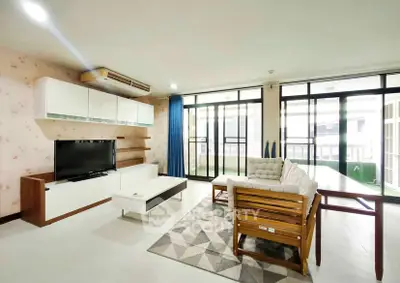 Spacious modern living room with large windows and stylish furniture