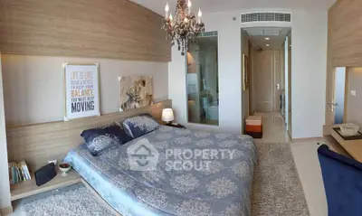 Luxurious bedroom with elegant chandelier and modern decor, perfect for relaxation and comfort.