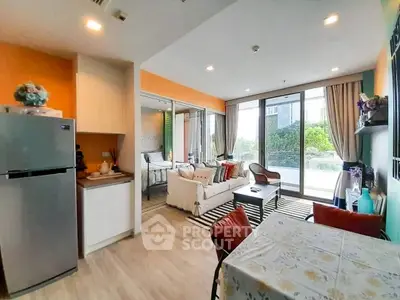 Modern open-plan living room with kitchen and balcony view