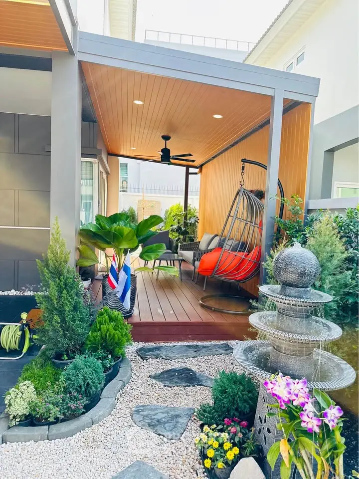 Charming outdoor patio with modern seating and lush garden, perfect for relaxation and entertaining.