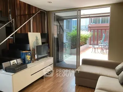 Modern living room with cozy sofa and access to spacious balcony