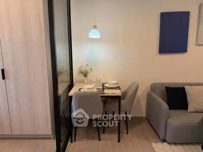 Cozy dining area with modern decor and comfortable seating in a stylish apartment.