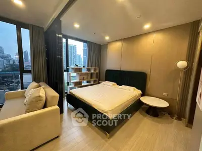 Modern bedroom with city view, featuring a cozy bed, stylish sofa, and elegant decor in a high-rise apartment.