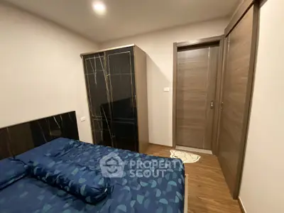 Modern bedroom with stylish wardrobe and cozy bedding in a contemporary apartment