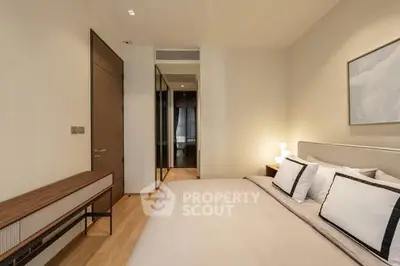 Elegant bedroom with modern decor and cozy lighting in a stylish apartment.