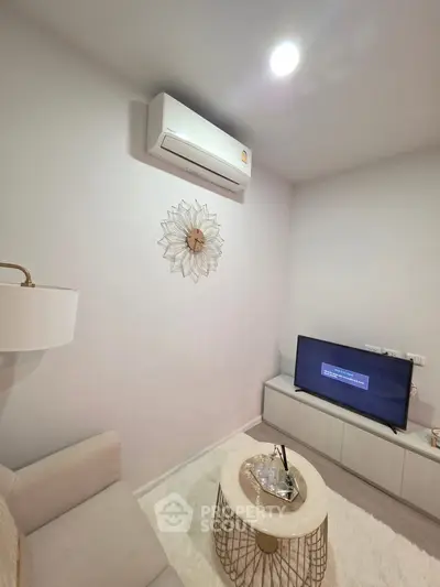 Cozy living room with modern decor, featuring a wall-mounted air conditioner and stylish furniture.