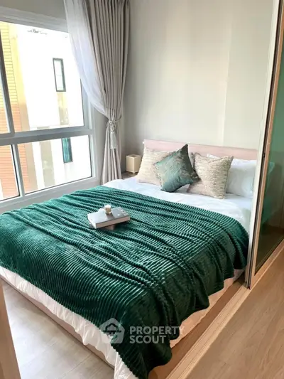Cozy bedroom with large window and stylish decor in modern apartment