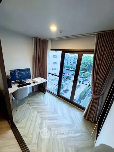 Modern study room with large window and city view, featuring sleek desk and computer setup.