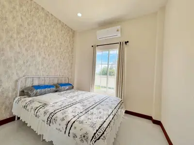 Cozy bedroom with stylish wallpaper and natural light