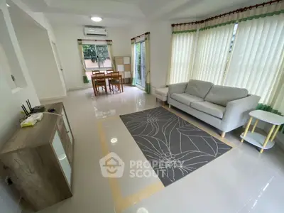 Spacious living room with modern furniture and large windows for natural light.