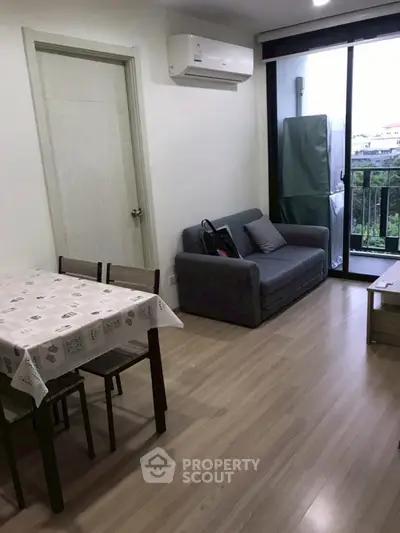 Cozy living room with balcony view and modern furnishings