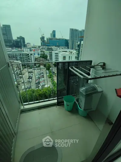 Urban balcony with city view and laundry setup, perfect for compact living.