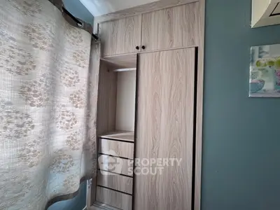 Modern wooden wardrobe with sliding doors in a stylish bedroom setting.