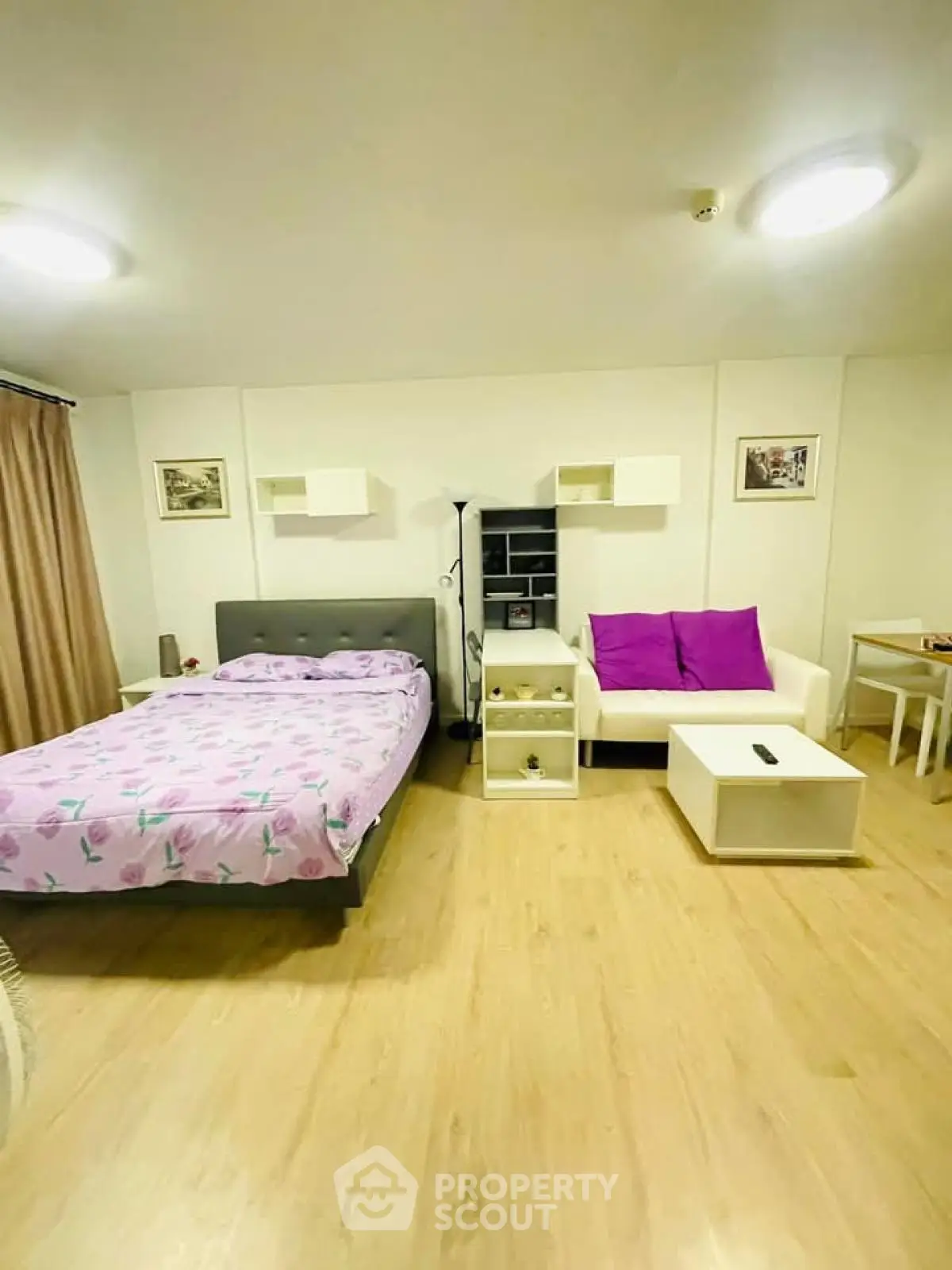 Cozy studio apartment with modern decor and wooden flooring