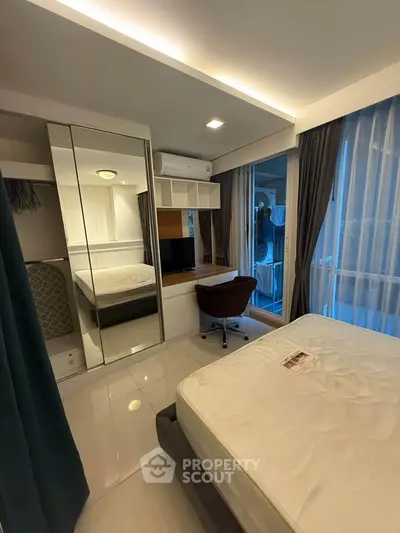 Modern bedroom with large windows and stylish furniture in a cozy apartment.