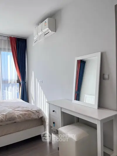 Bright and cozy bedroom with modern furnishings and natural light, perfect for relaxation.