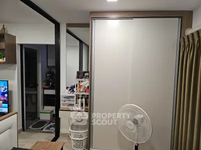 Compact modern bedroom with sliding closet doors and organized vanity area