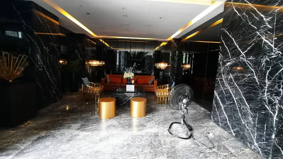 Luxurious building lobby with elegant marble finishes and modern seating area.