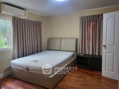 Cozy bedroom with modern furnishings and natural light, perfect for relaxation.