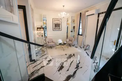 Luxurious living room with elegant chandelier and marble flooring