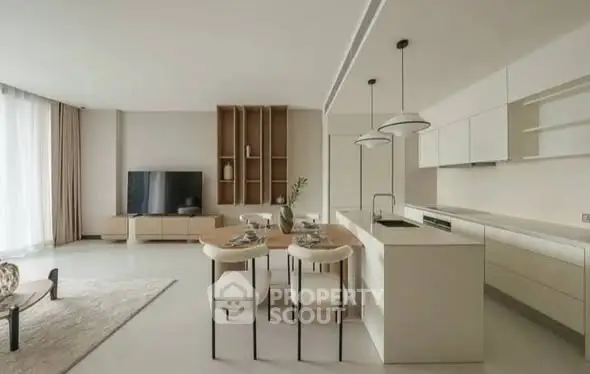 Modern open-plan living room with sleek kitchen and stylish decor