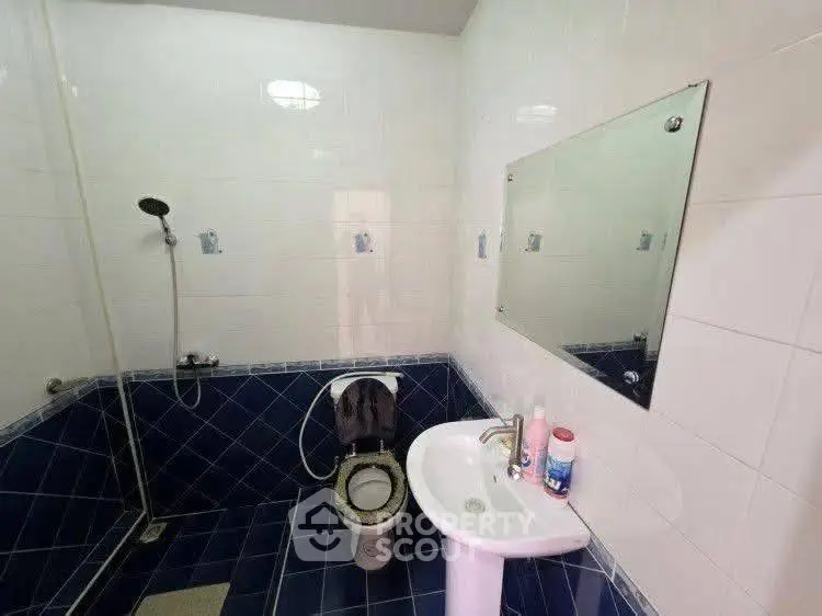 Modern bathroom with blue tile accents and sleek fixtures