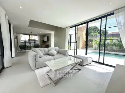 Spacious modern living room with pool view and elegant furnishings