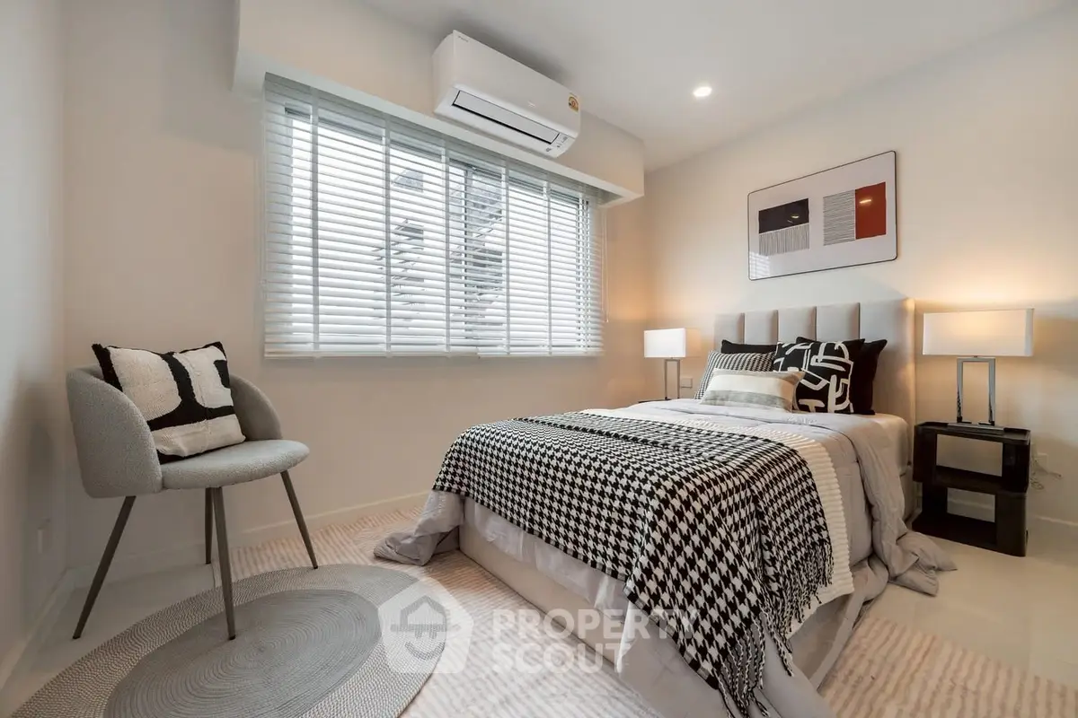 Modern bedroom with stylish decor and natural light
