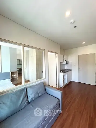 Modern apartment interior with cozy living room and compact kitchen