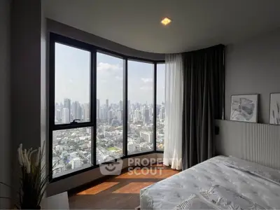 Luxurious bedroom with panoramic city view and modern decor in high-rise apartment.